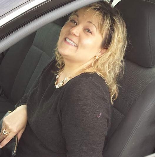 A woman sitting in the passenger seat of a car.