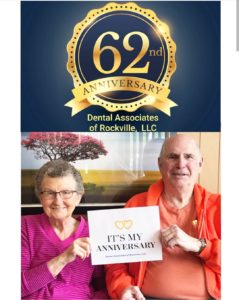 A couple holding up a sign that says 6 2 nd anniversary dental associates of rockville, llc.