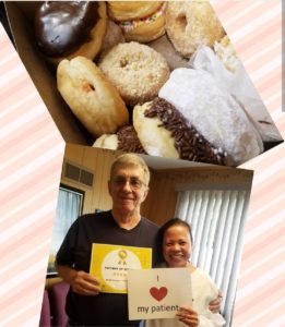 donuts and two people posing for a camera