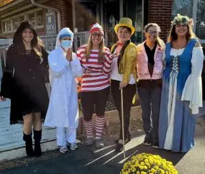 Group of women dressed in costumes.