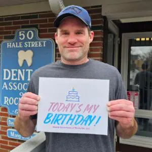 Man holding a "Today's My Birthday" sign.