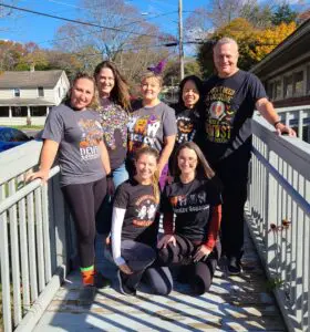 Dental team in Halloween costumes on bridge.