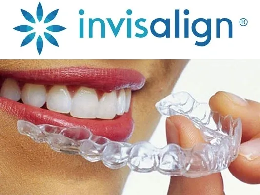 Person holding clear dental aligner, smiling.